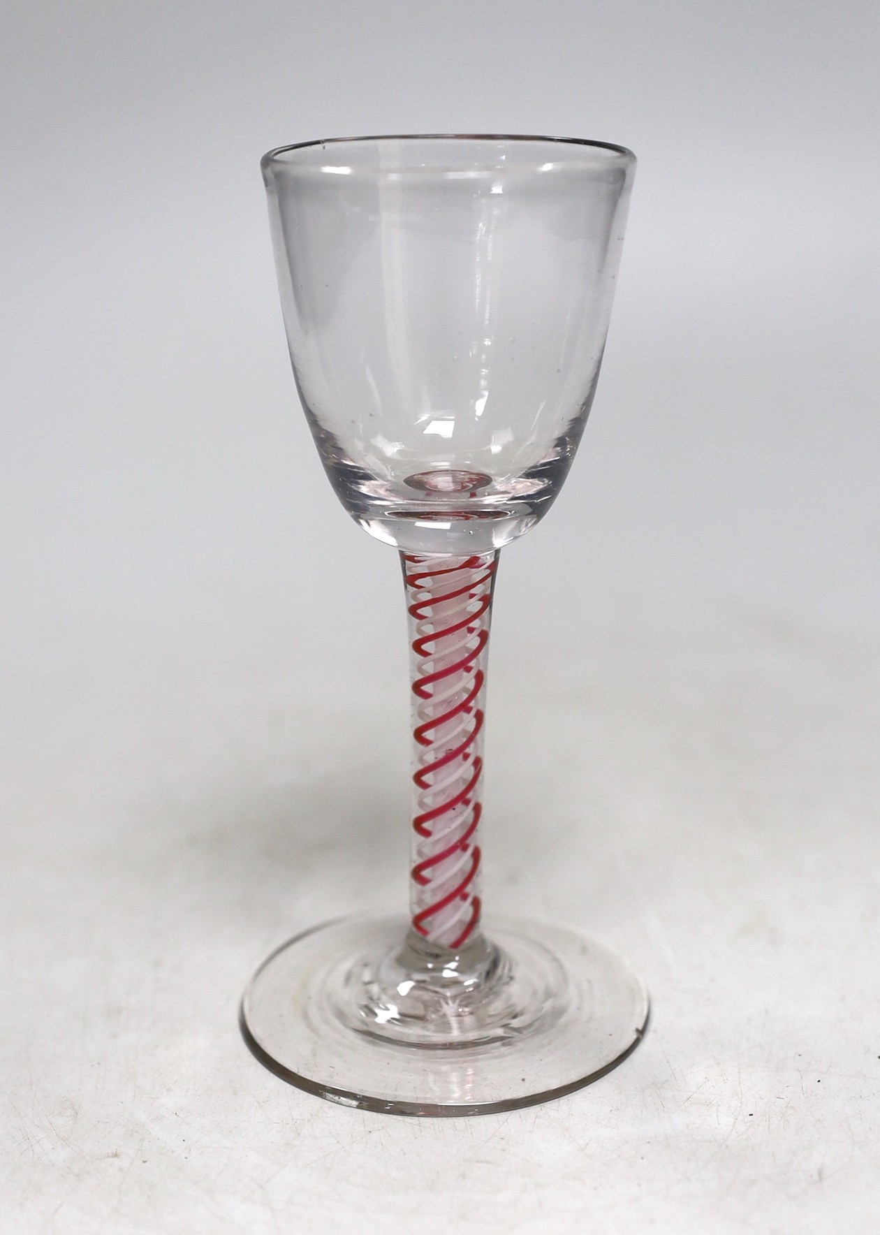 A Dutch red and white colour twist stem wine glass. 15cm tall